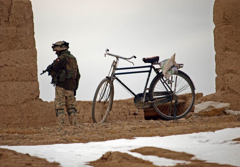 Soldier with bicycle in desert