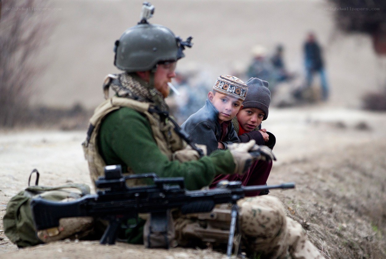 Soldier with children in conflict zone