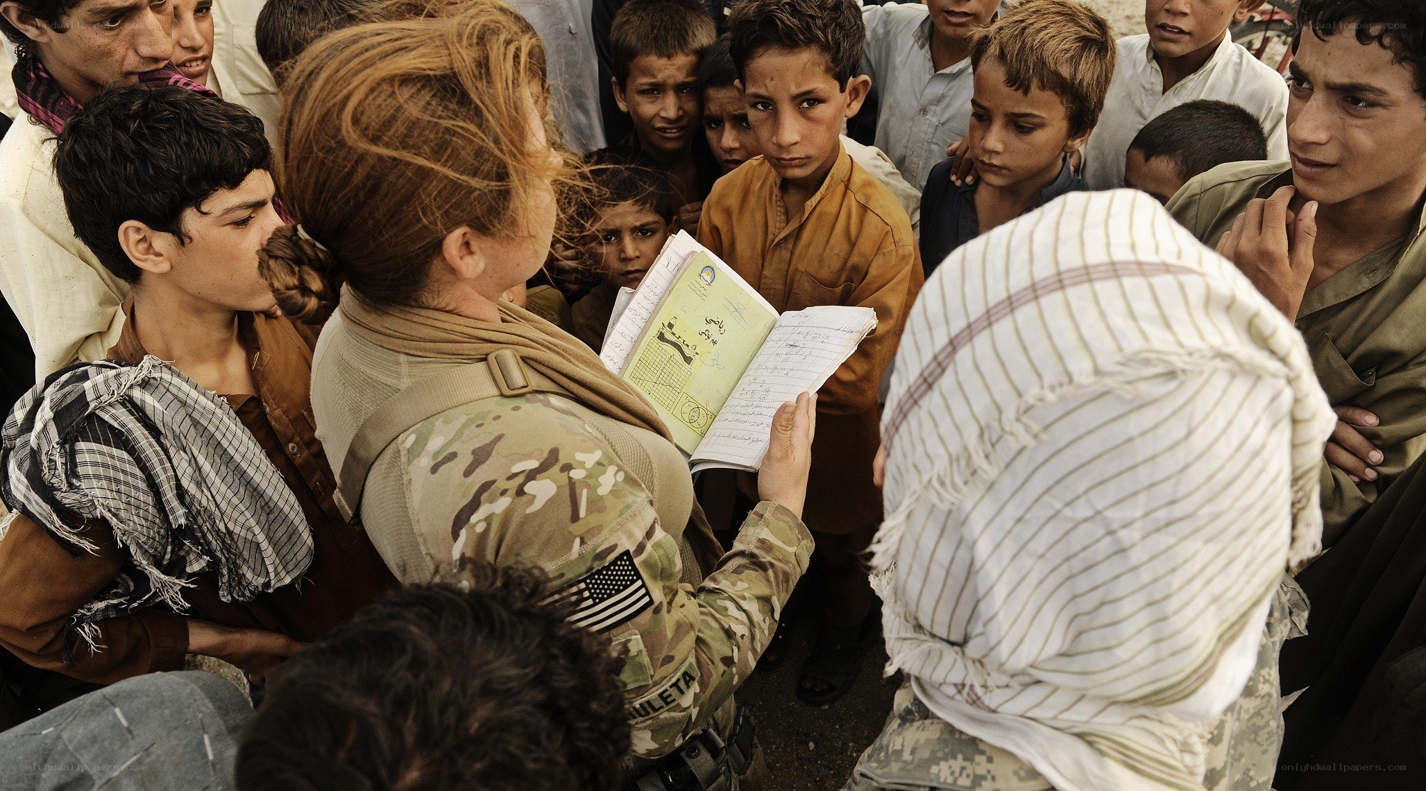 Soldier with children in refugee camp