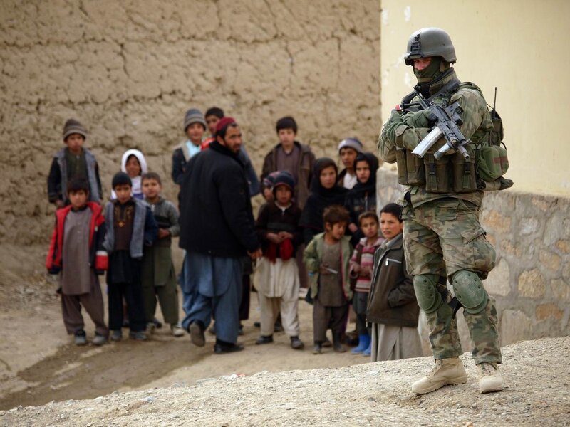 Soldier with children in village