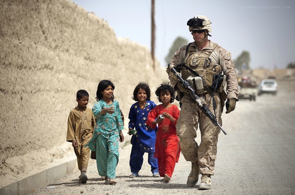 Soldier with children on road