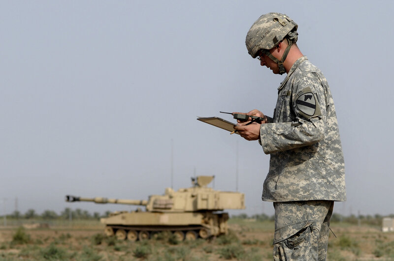 Soldier with clipboard near tank