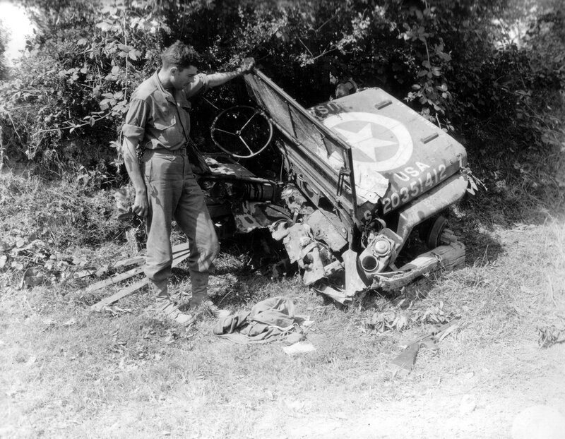 Soldier with damaged military vehicle