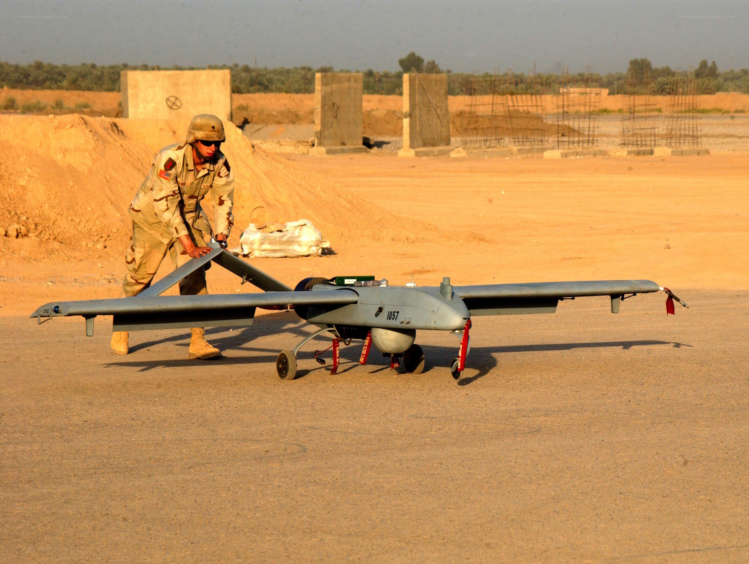 Soldier with drone at desert base