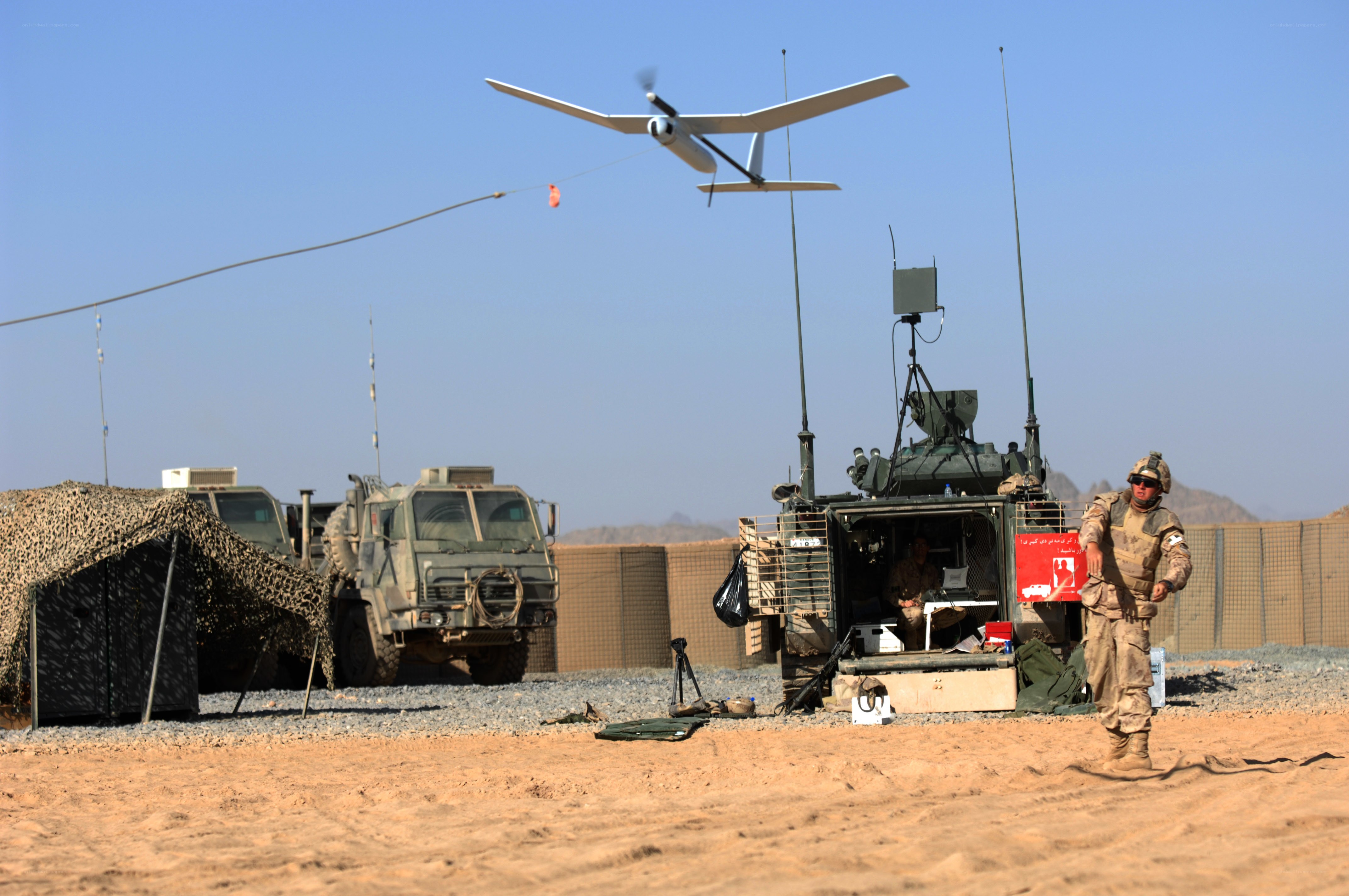 Soldier with drone in desert