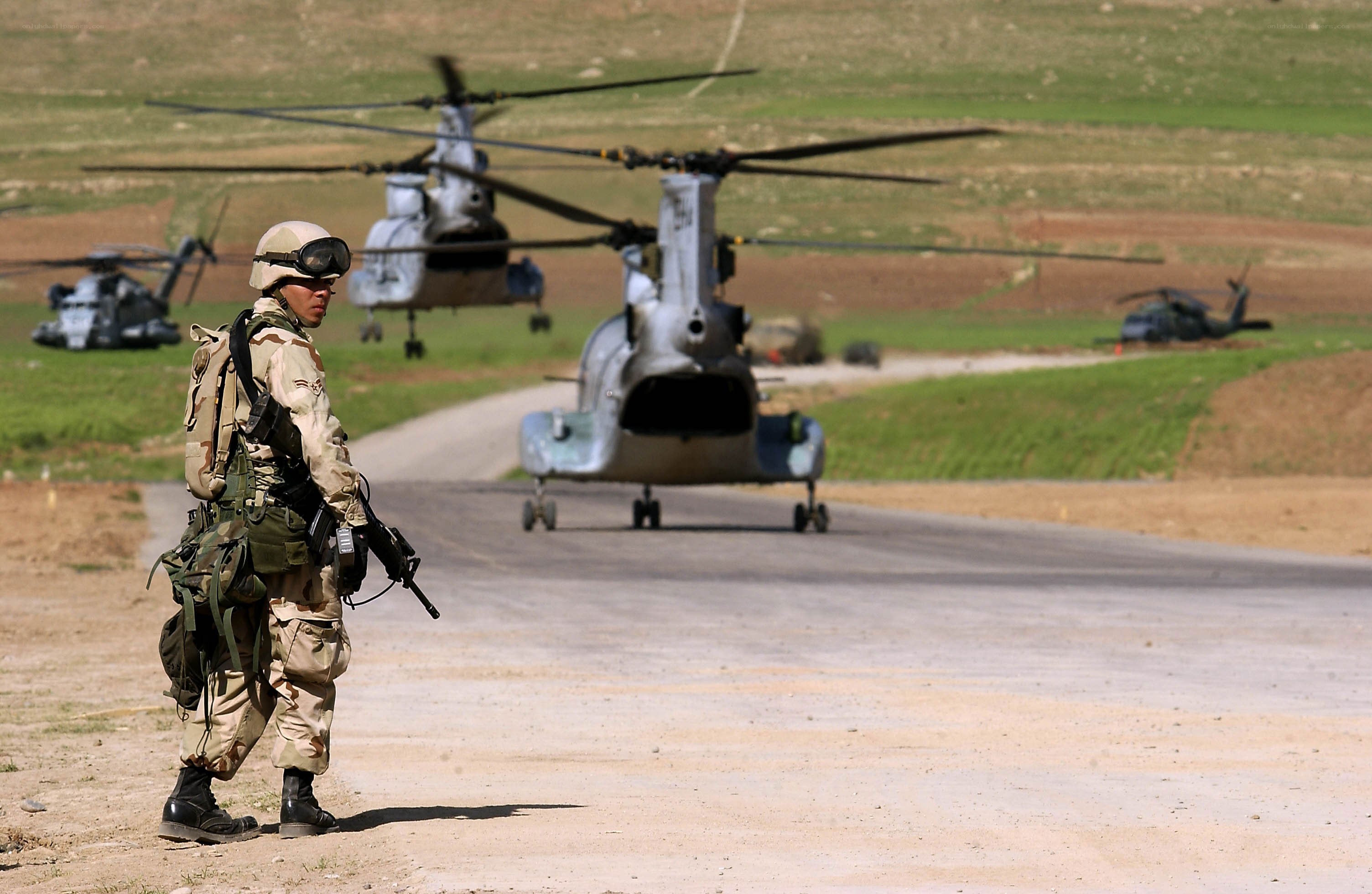 Soldier with helicopter in background