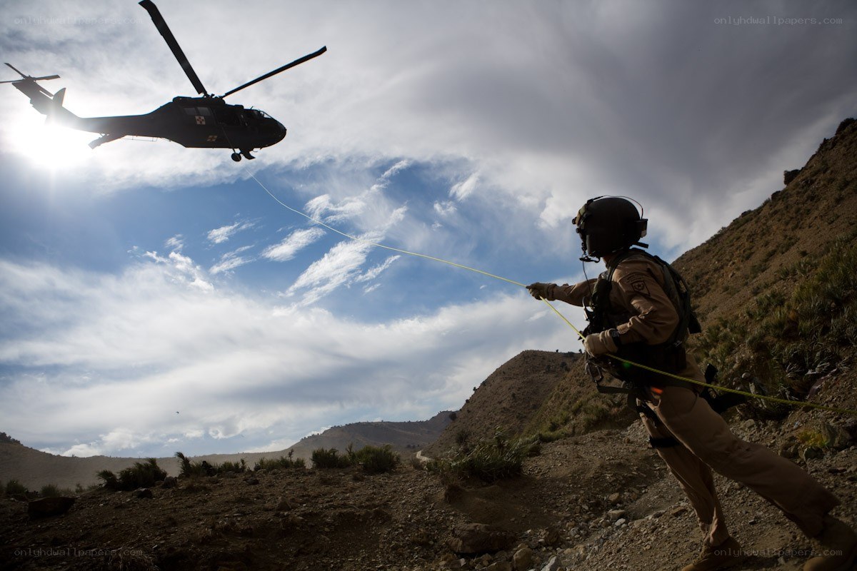 Soldier with helicopter in mountains