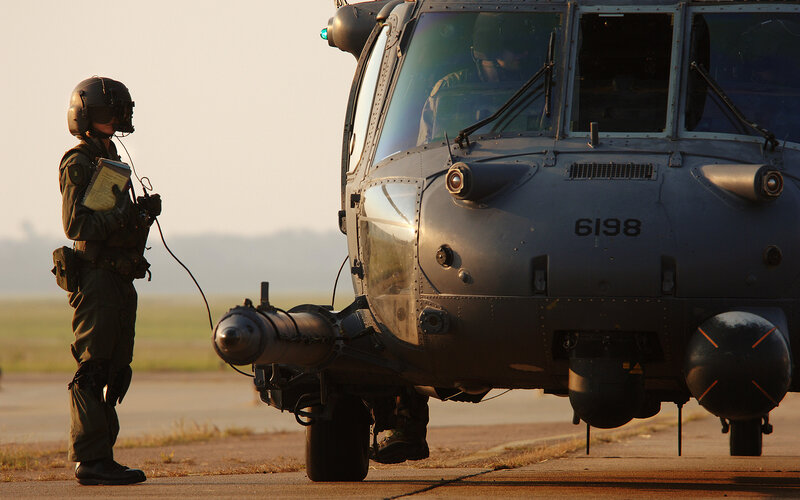 Soldier with helicopter on tarmac