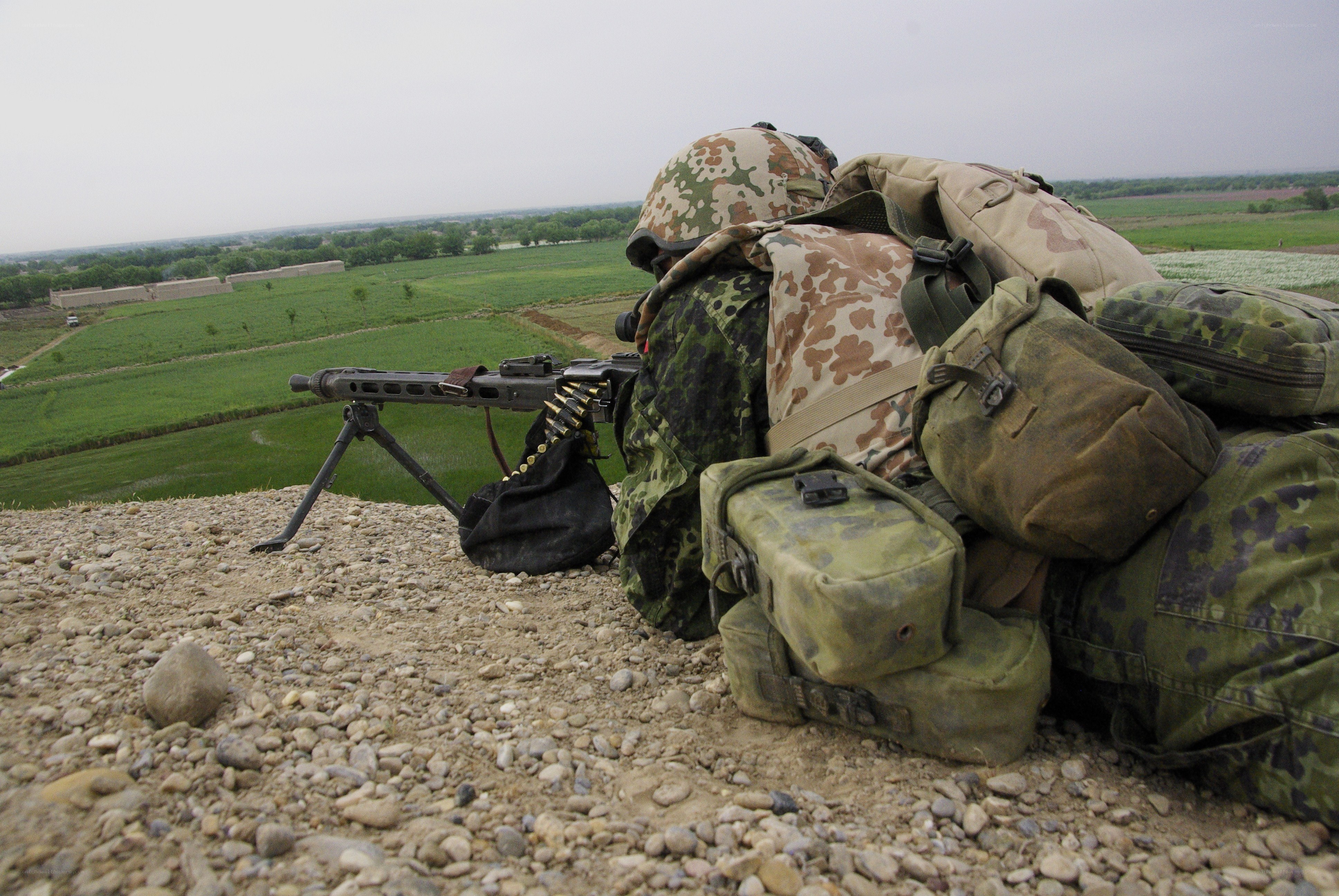 Soldier with machine gun in field