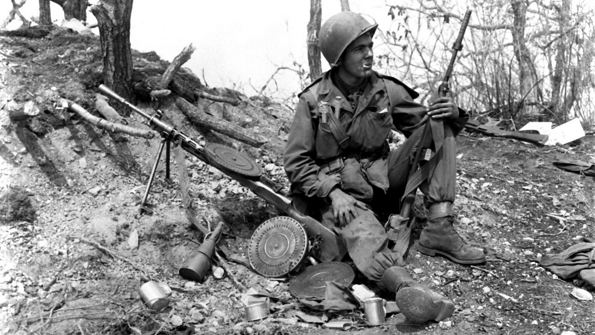 Soldier with machine gun in foxhole