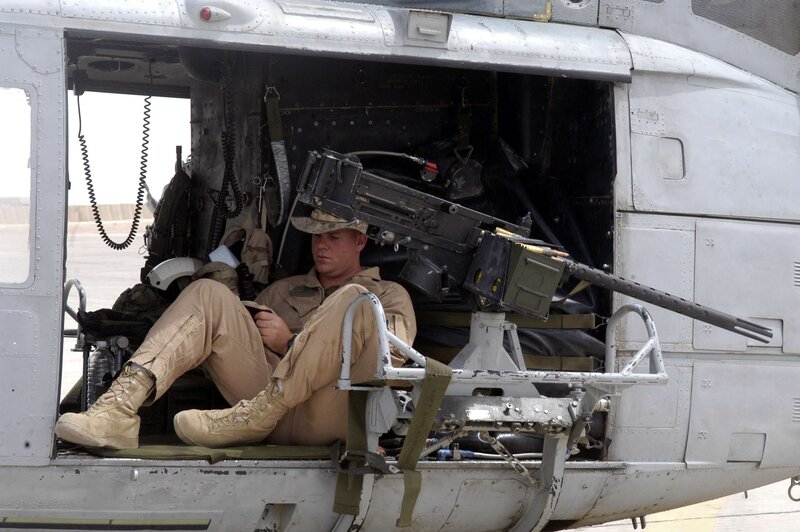 Soldier with machine gun in helicopter
