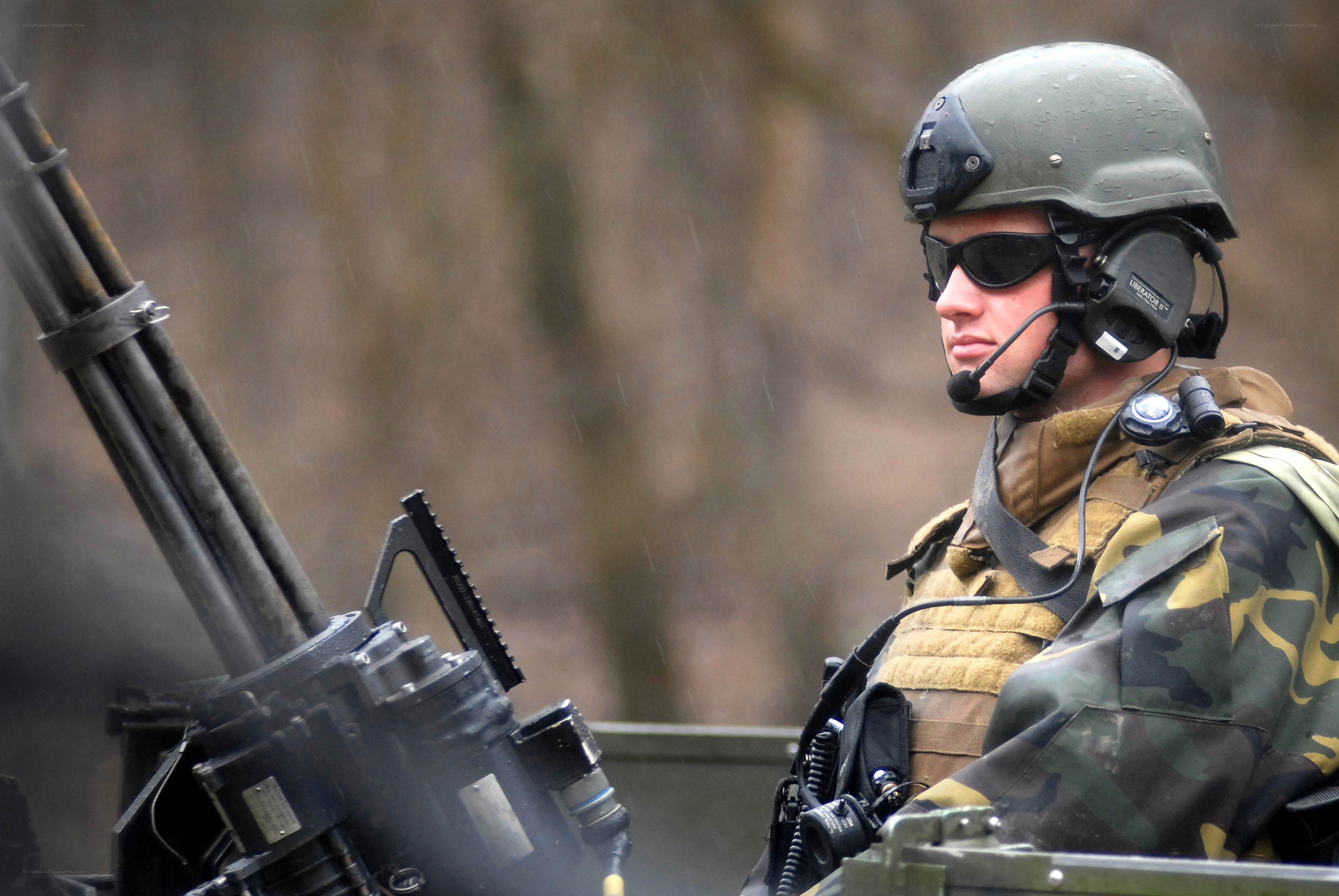 Soldier with machine gun in rain