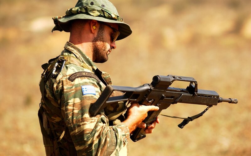 Soldier with rifle in camouflage