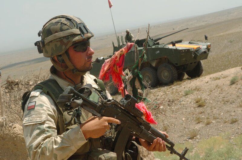Soldier with rifle in desert