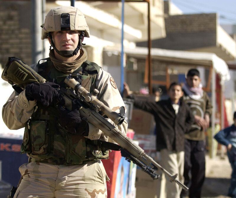 Soldier with rifle in urban area