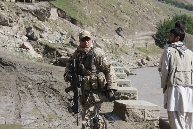 Soldier with rifle near river