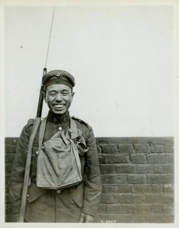 Soldier with rifle smiling