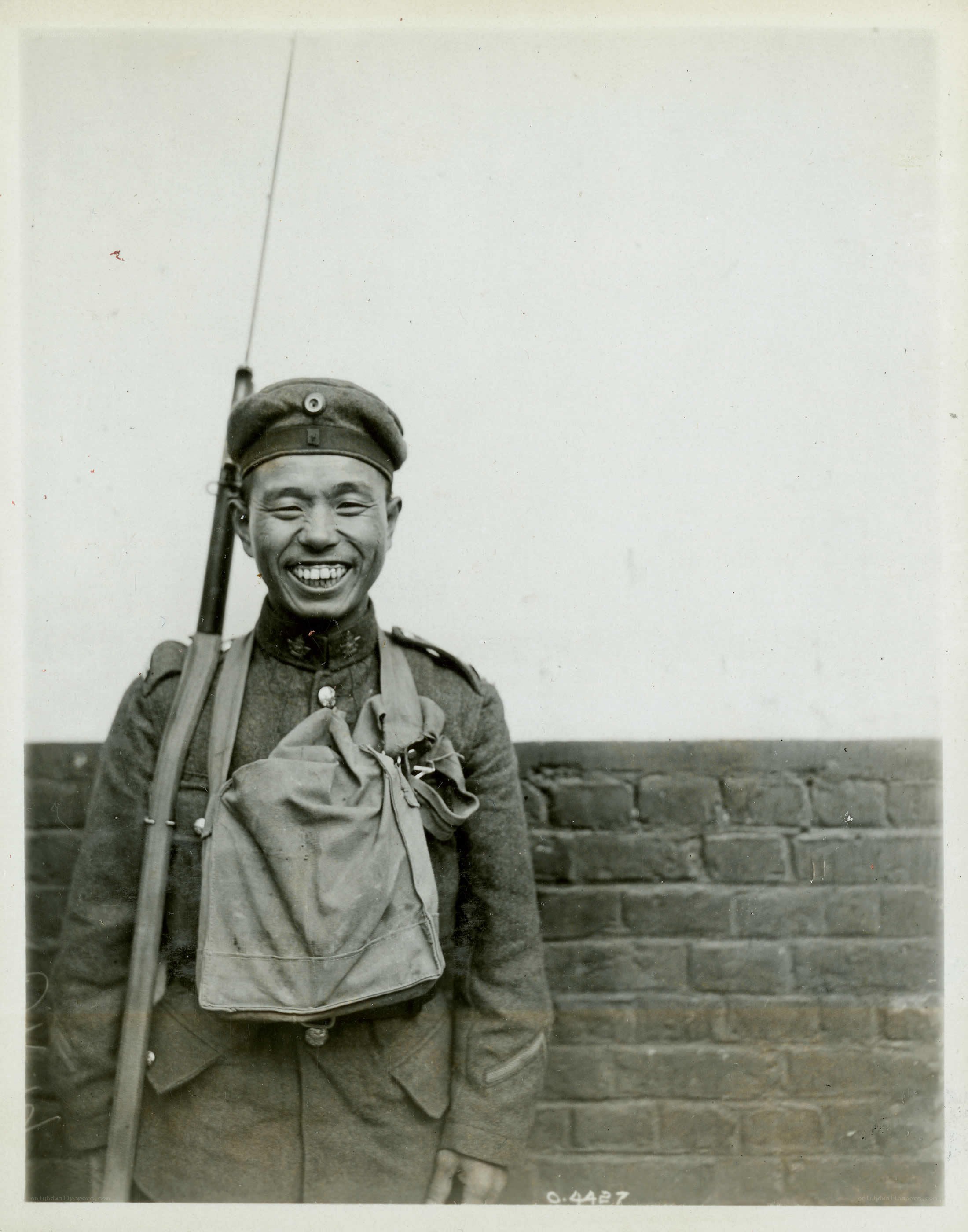 Soldier with rifle smiling