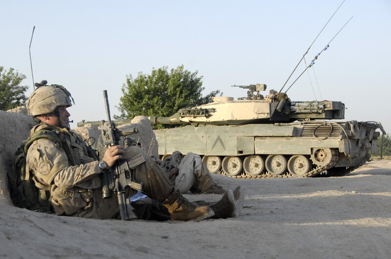 Soldier with tank in desert