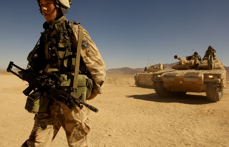 Soldier with tank in desert