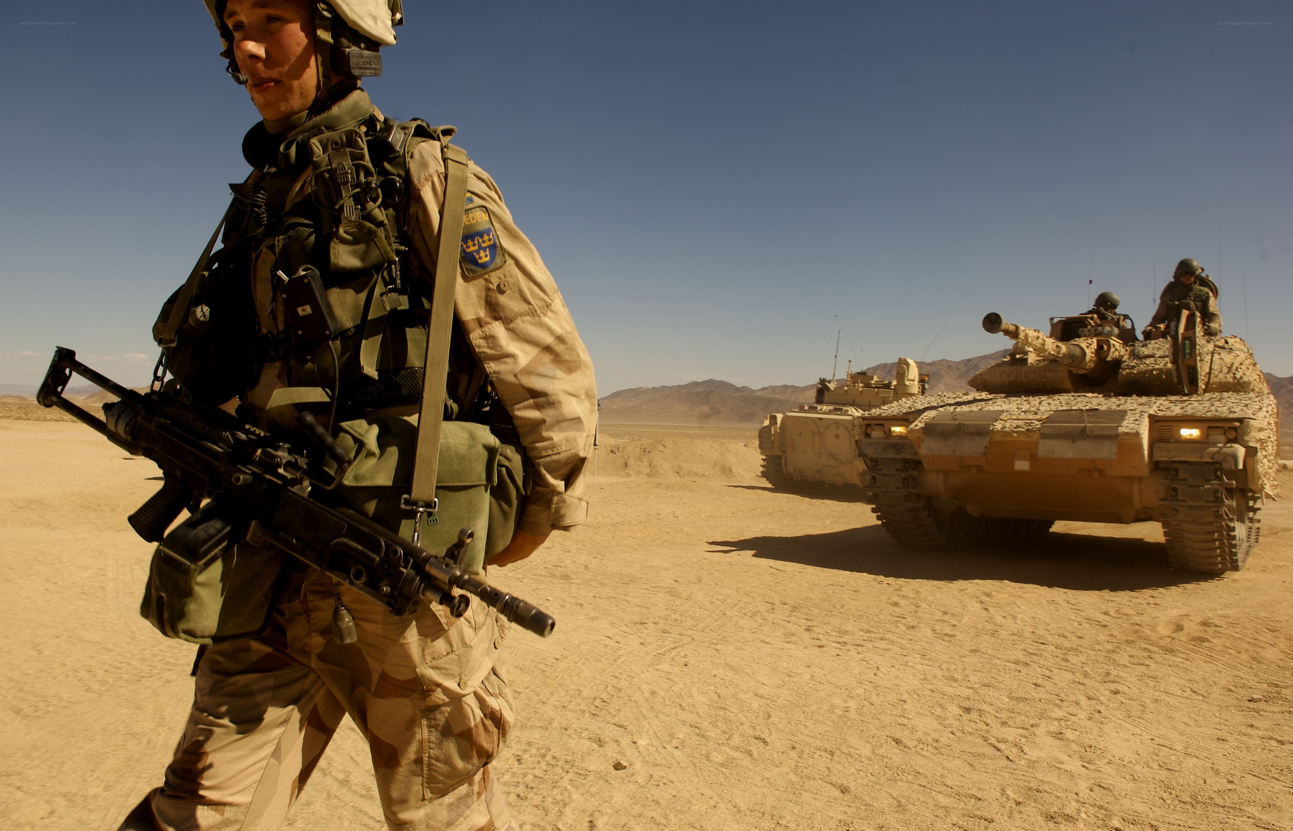 Soldier with tank in desert