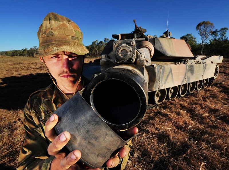 Soldier with tank in field
