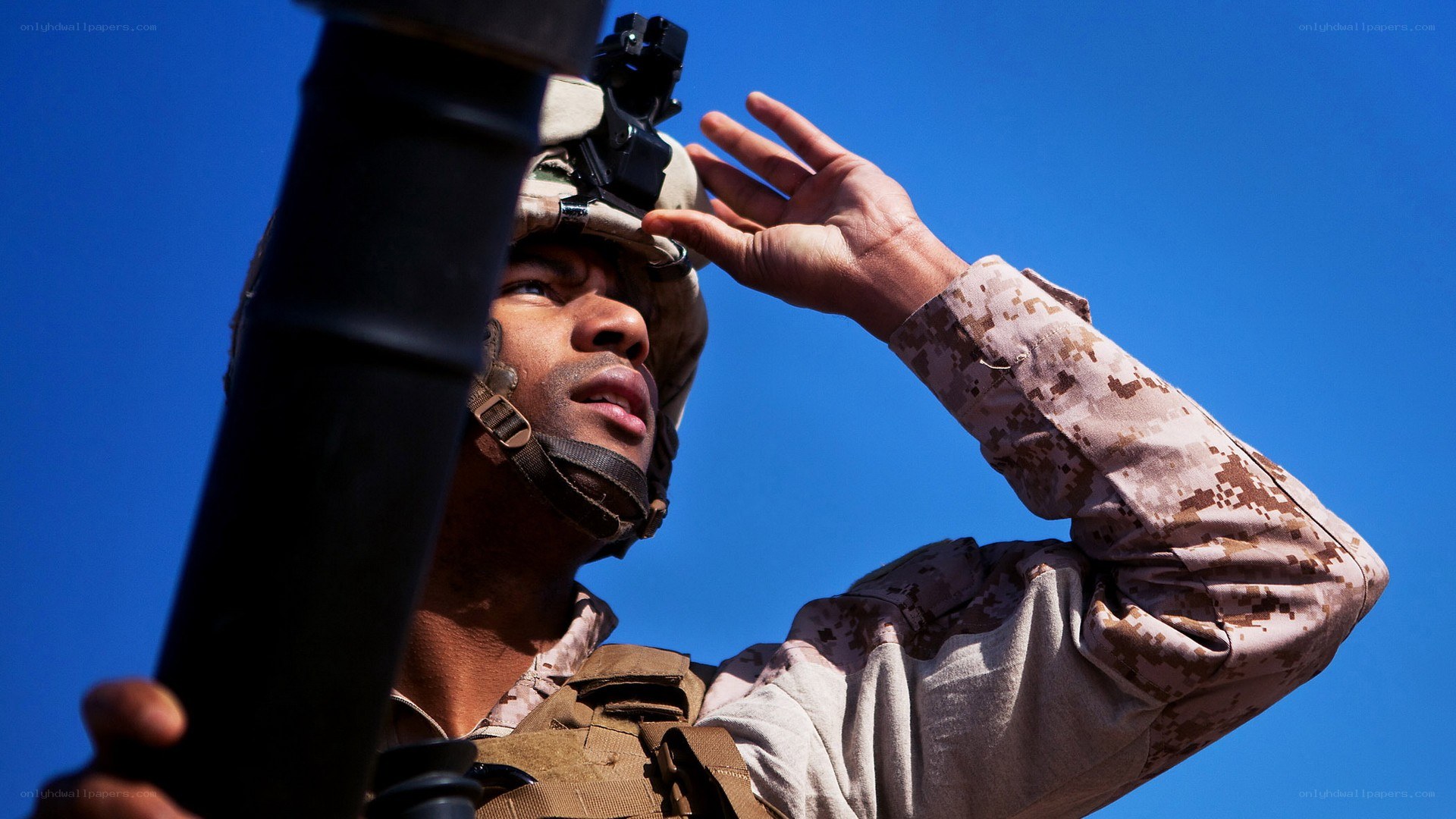 Soldier with weapon under blue sky