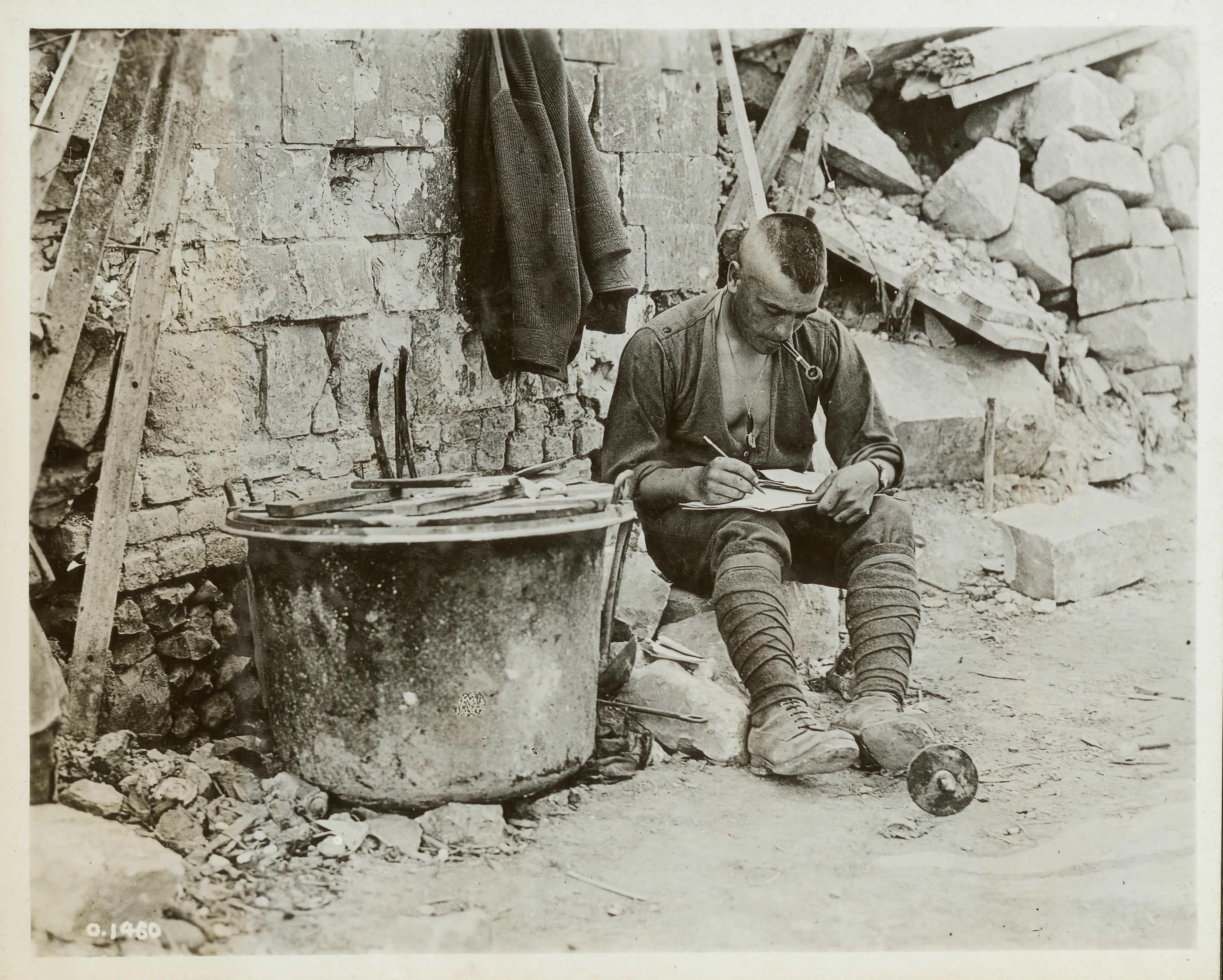 Soldier writing in a war zone
