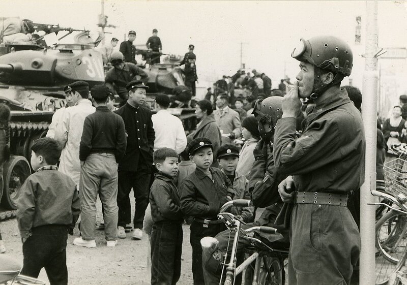 Soldiers and civilians in a street scene