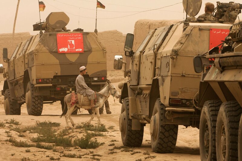 Soldiers and donkey in desert