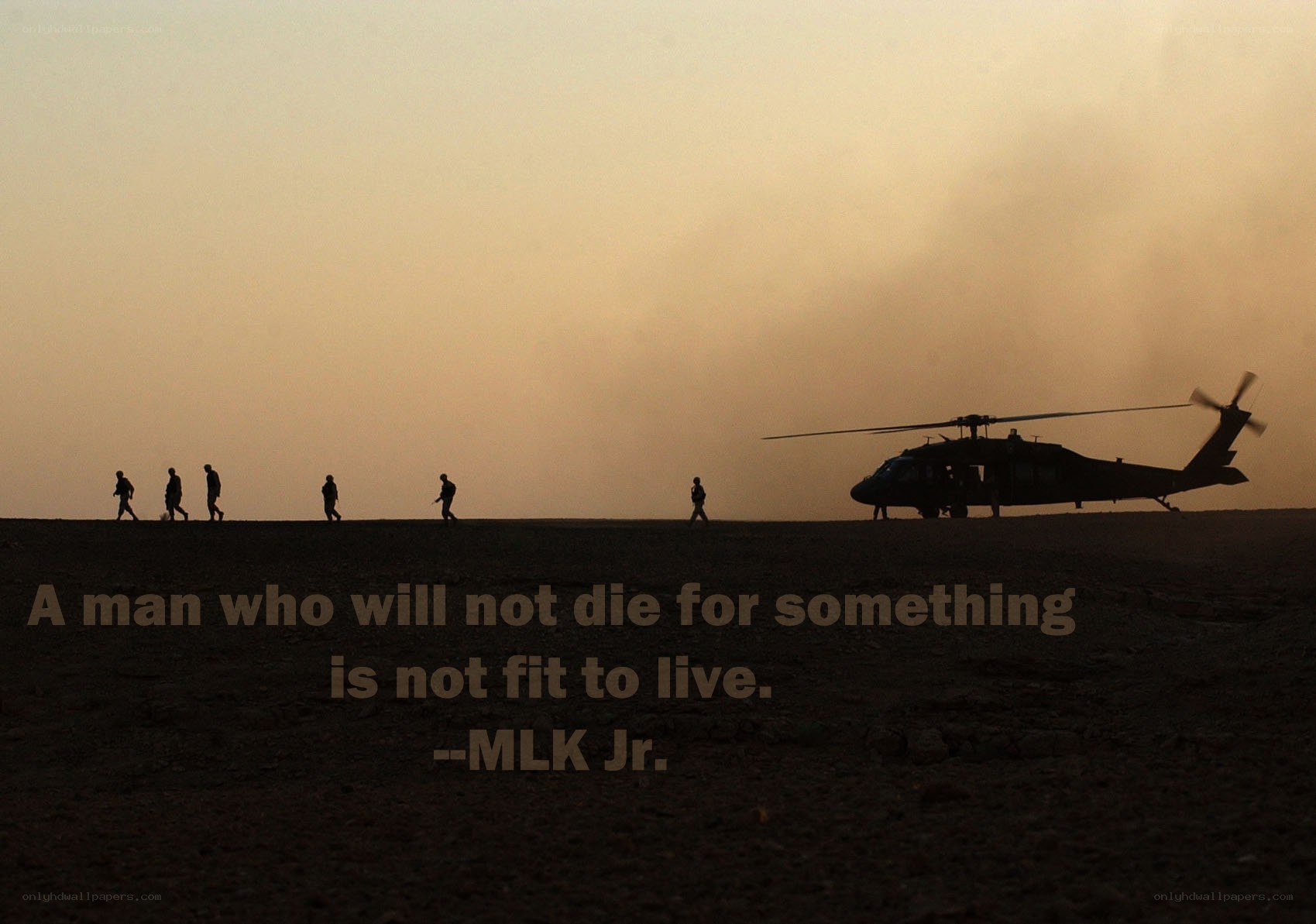 Soldiers and helicopter at dusk