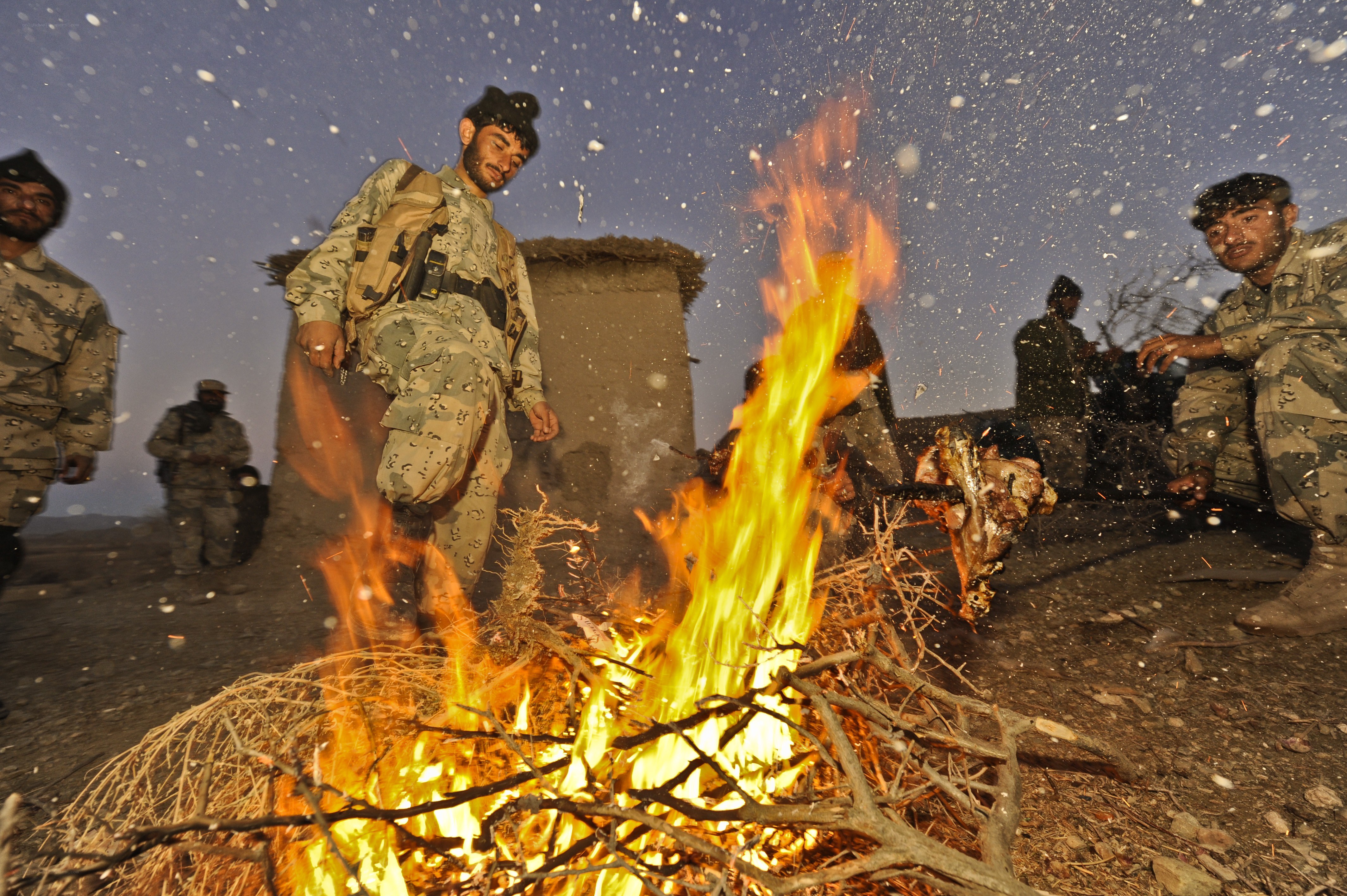 Soldiers around a fire in snow
