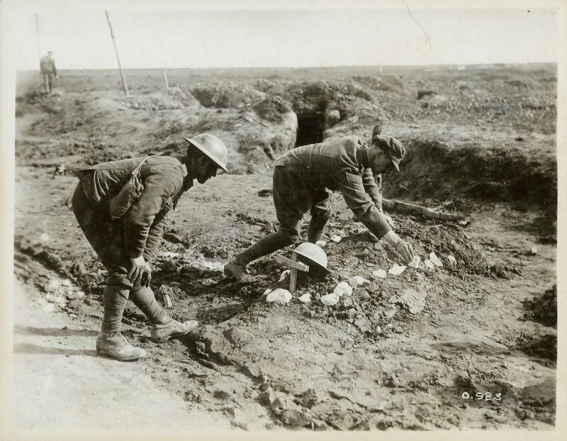 Soldiers at a grave in a trench