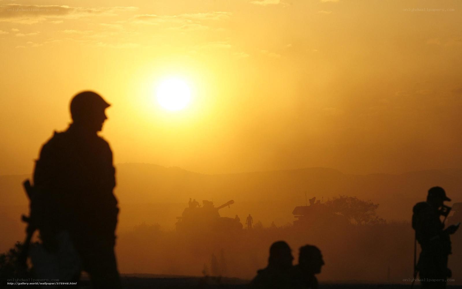 Soldiers at sunset with tanks