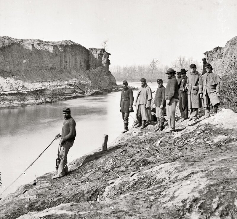 Soldiers by a riverbank