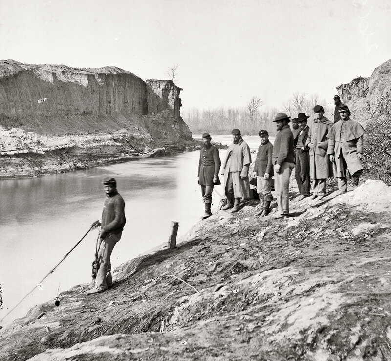 Soldiers by a riverbank