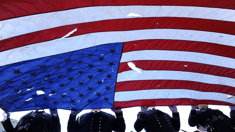 Soldiers carrying a tattered flag