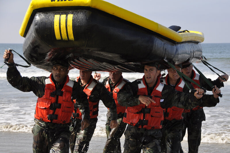 Soldiers carrying inflatable boat
