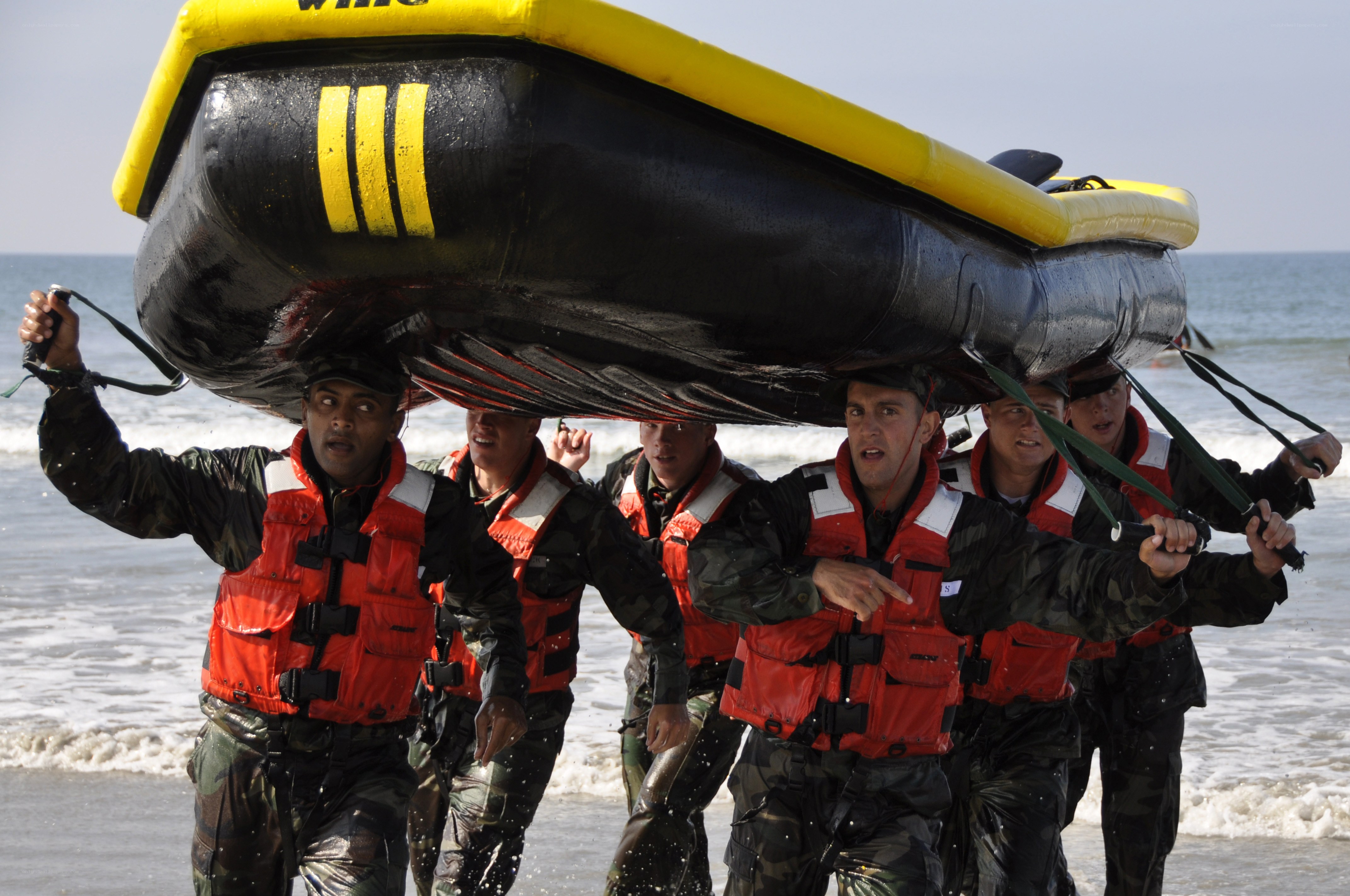 Soldiers carrying inflatable boat