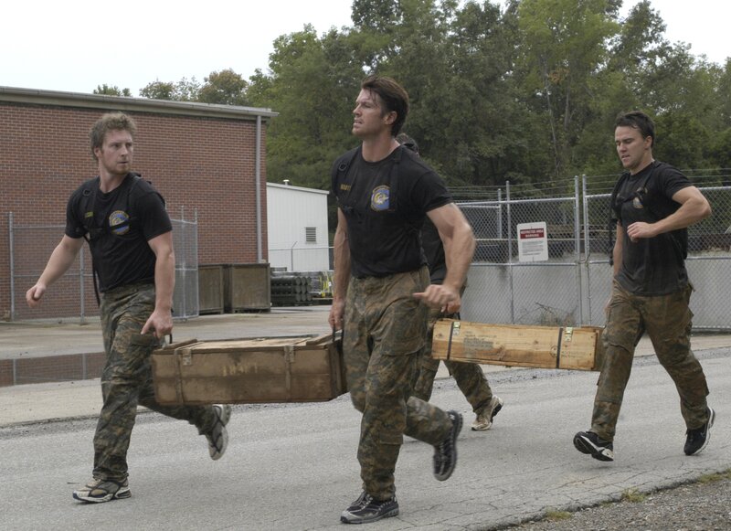 Soldiers carrying wooden crates