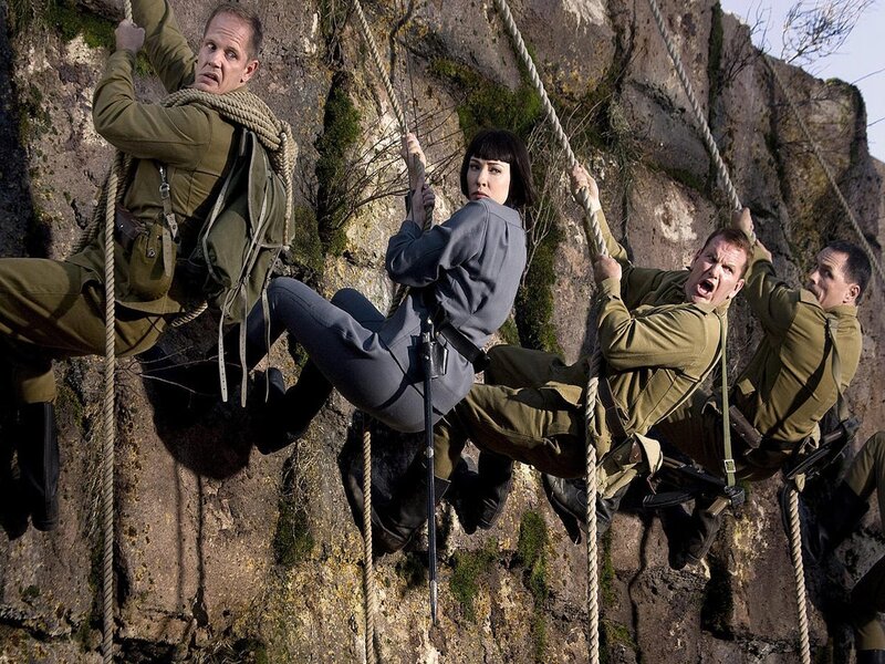 Soldiers climbing a cliff