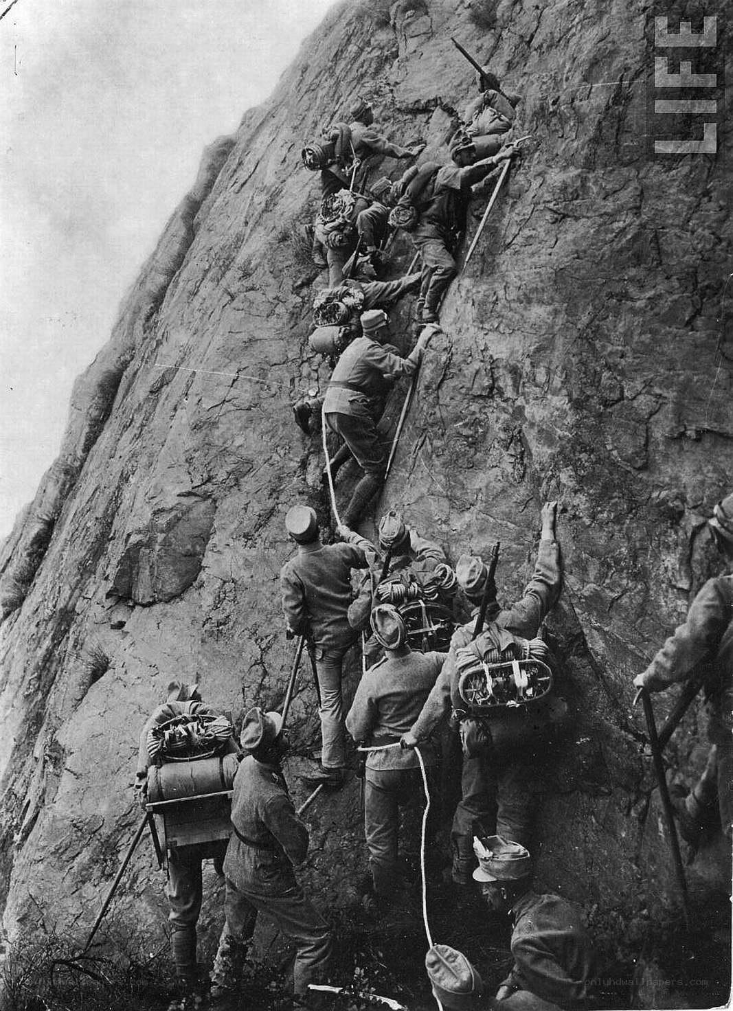 Soldiers climbing a cliff