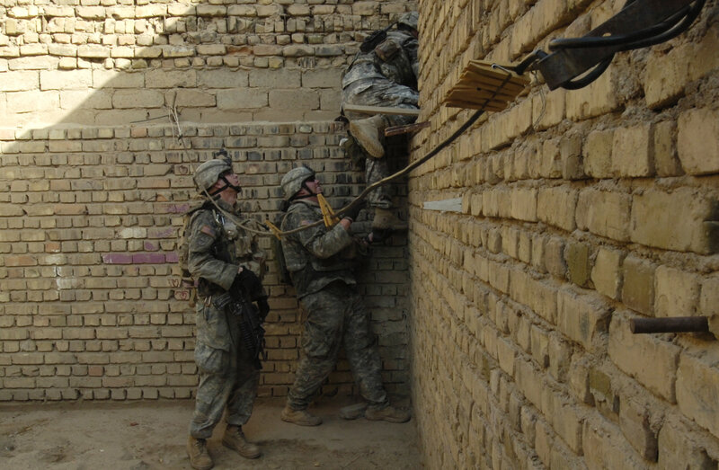 Soldiers climbing a wall