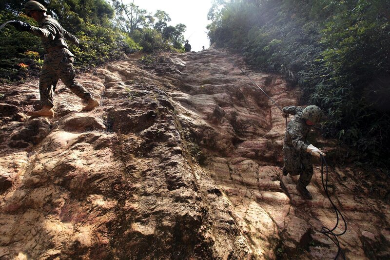 Soldiers Climbing Rock