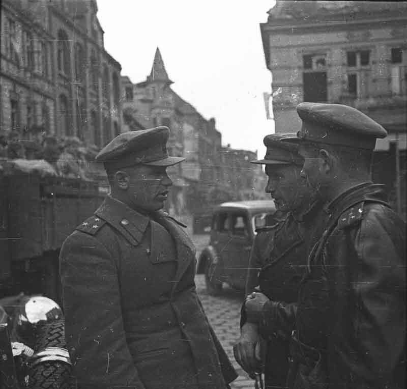 Soldiers conversing on a city street