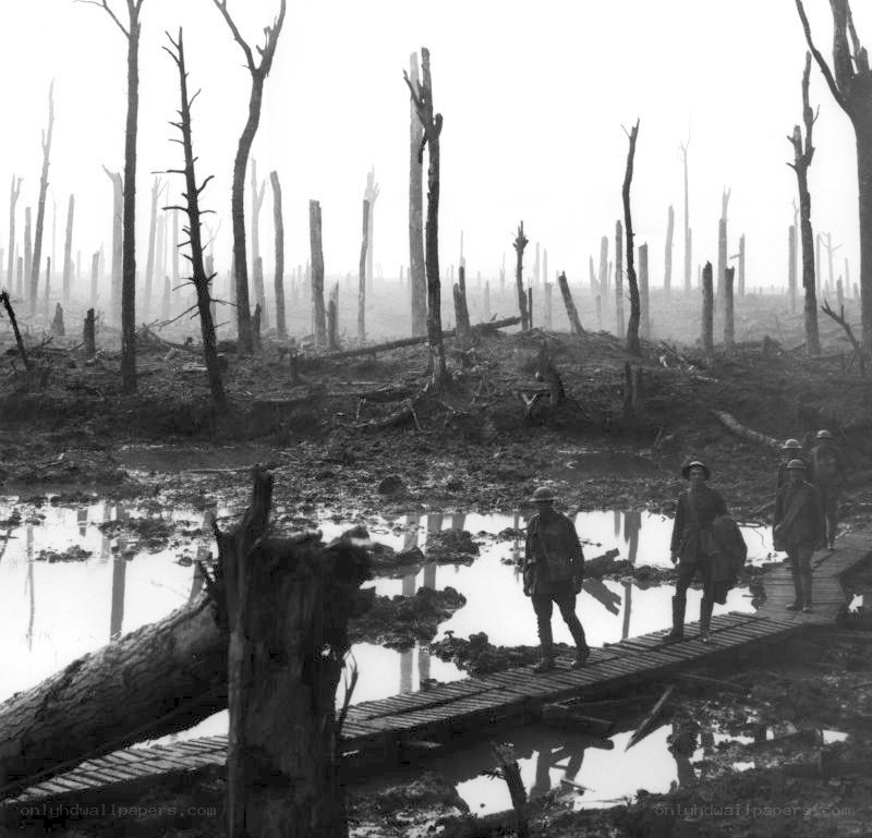 Soldiers crossing a muddy trench