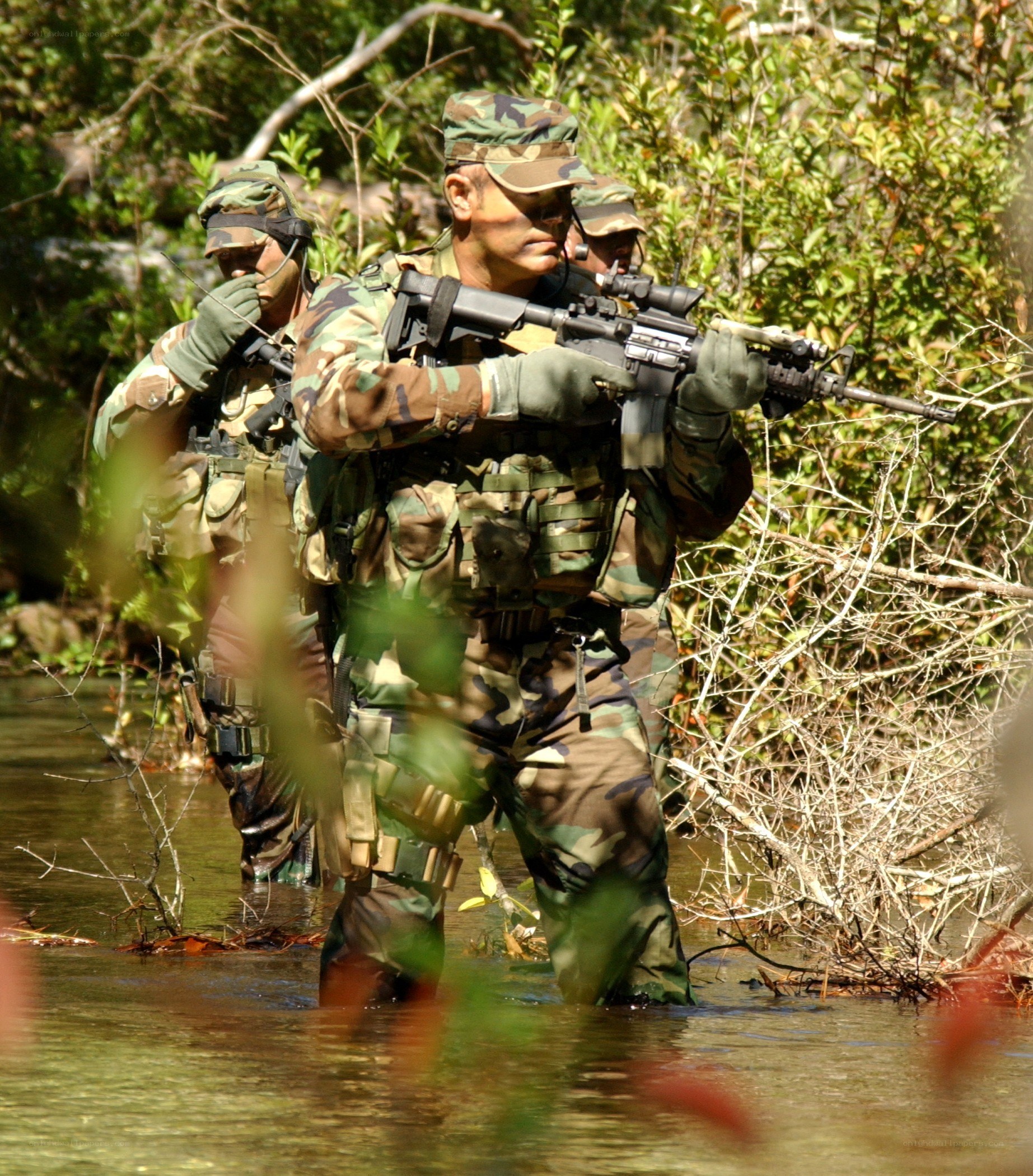 Soldiers crossing a river