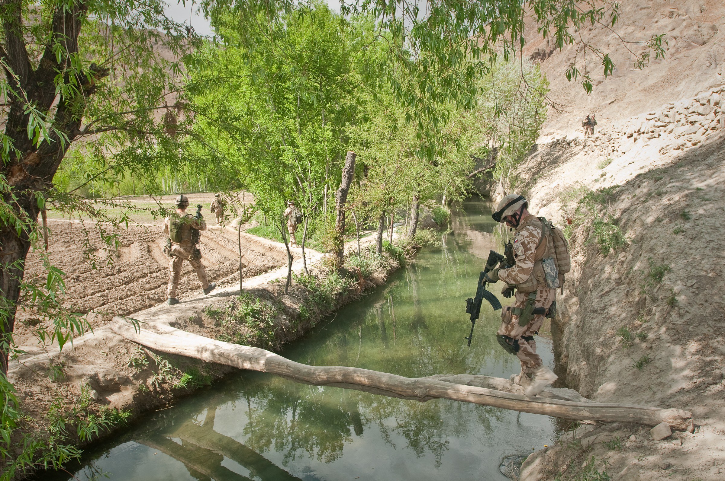 Soldiers crossing a stream