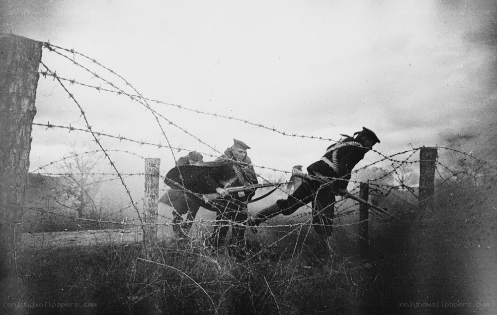Soldiers crossing barbed wire