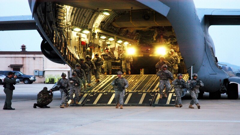Soldiers disembarking from transport aircraft